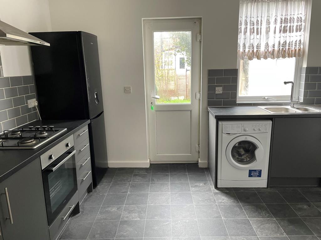 Lot: 21 - COTTAGE FOR INVESTMENT OR OCCUPATION - Kitchen with door to rear garden